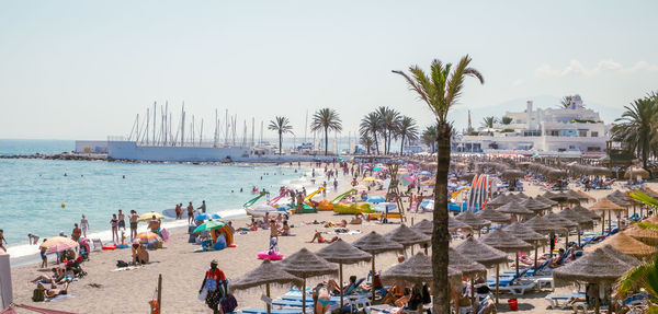 Holidaymakers sunbathing on venus beach, marbella city, province of malaga, spain, western europe.