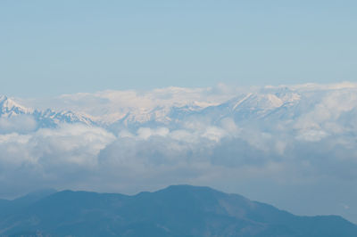 Scenic view of mountains against blue sky