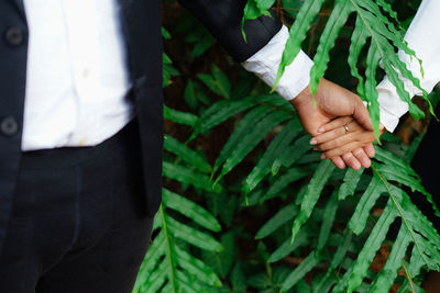 Low section of couple holding hands