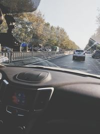 Close-up of cars on road against sky