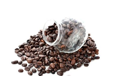 Close-up of coffee beans against white background