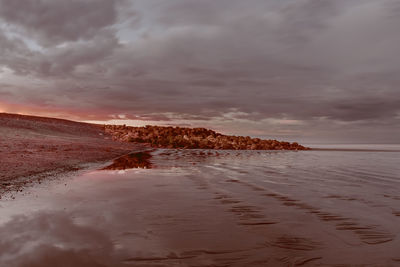 Scenic view of beach against sky during sunset