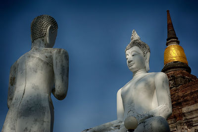 Low angle view of statue against temple against sky