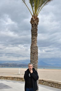Portrait of man standing against sky