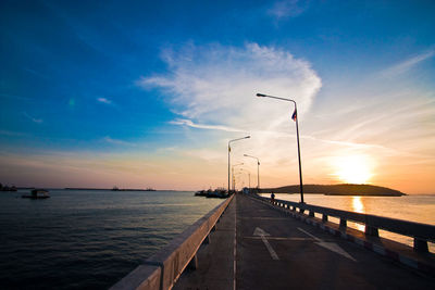 View of pier on sea against cloudy sky