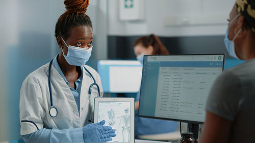 Doctor showing digital tablet to patient