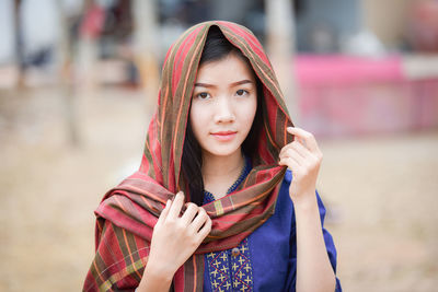 Portrait of beautiful young woman with scarf