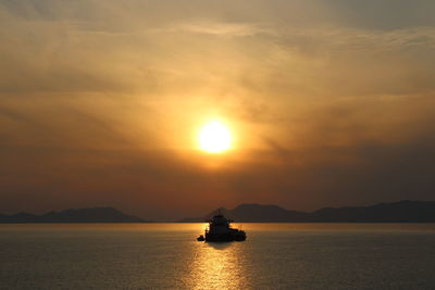 Scenic view of sea against orange sky