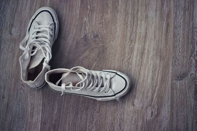 Directly above shot of shoes on wooden table