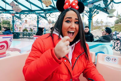 Portrait of smiling young woman in amusement park