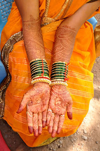 Low section of woman standing on carpet