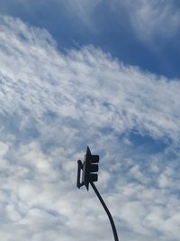 Low angle view of road signal against sky