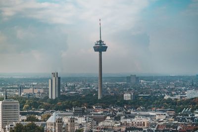 View of cityscape against cloudy sky