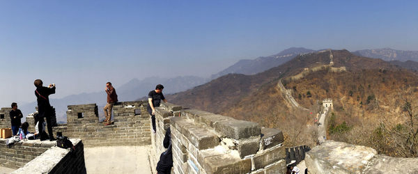 People at great wall of china against sky