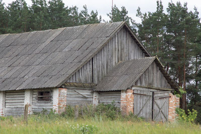 Exterior of house on field against trees