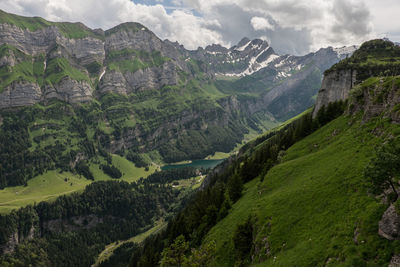 Scenic view of mountains against cloudy sky