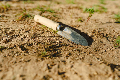 Close-up of cigarette on sand