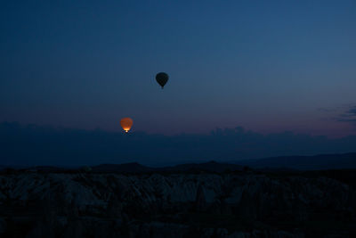 Hot air balloons against sky at sunset