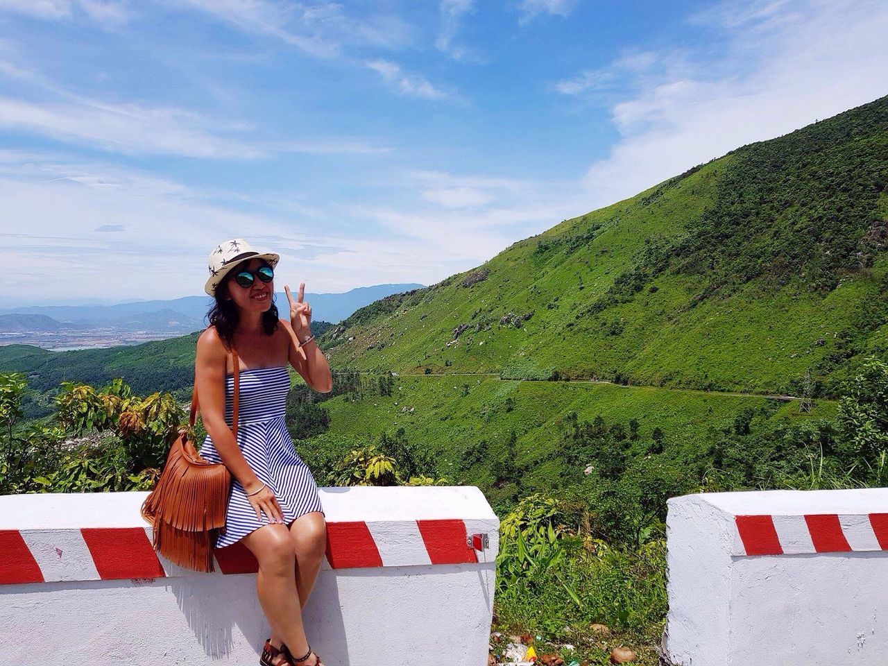 leisure activity, sky, young adult, real people, lifestyles, young women, sunglasses, one person, casual clothing, standing, outdoors, nature, cloud - sky, beauty in nature, day, scenics, mountain, vacations, women, beautiful woman, full length, smiling, tree, people