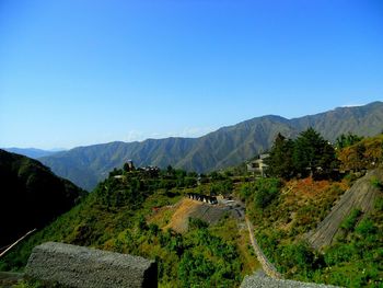 Scenic view of mountains against clear blue sky