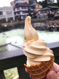 Close-up of hand holding ice cream cone