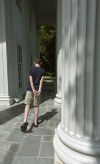 Rear view of woman walking in building