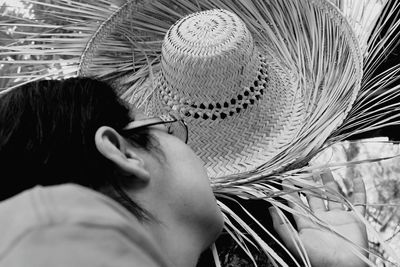 Low angle view of woman holding straw hat