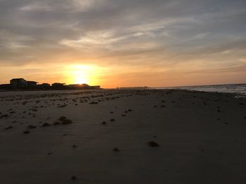 Scenic view of beach against sky during sunset