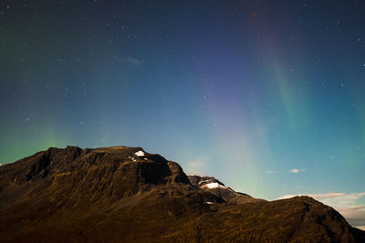 Low angle view of mountain against sky at night