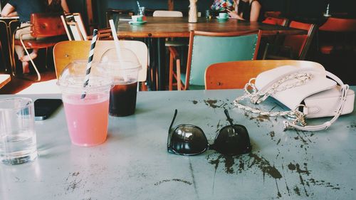Close-up of drinks and sunglasses on table