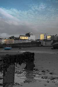 Buildings by sea against sky in city