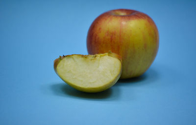 Close-up of apple against blue background