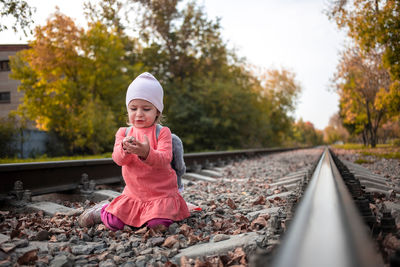 Portrait of boy standing on railroad track