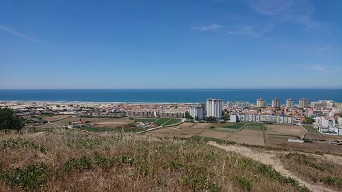 Scenic view of beach against blue sky