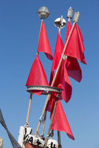 Low angle view of red umbrella against sky