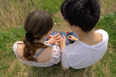 High angle view of women sitting on grass