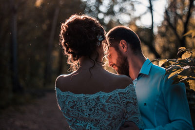 Couple standing in forest