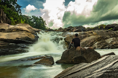 Rear view of waterfall against rocks