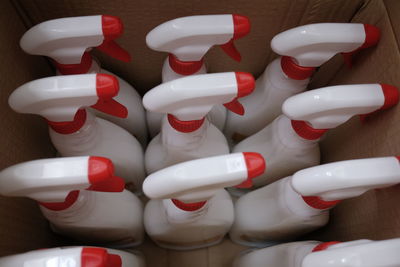 Close-up of spray bottles in cardboard box