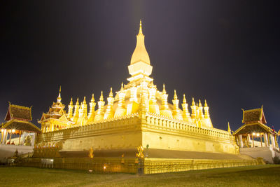 Illuminated buildings in city against sky at night