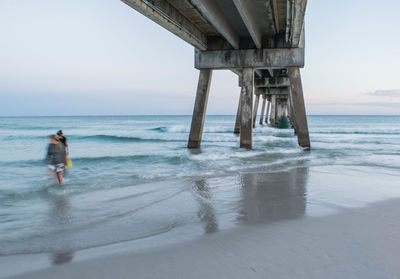 Full length of beach pier against sky