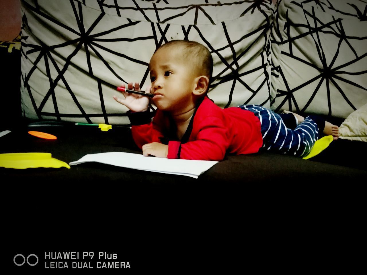 BOY WITH BOOK ON SHELF