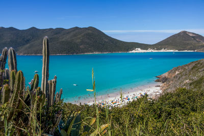 Scenic view of sea and mountains against sky