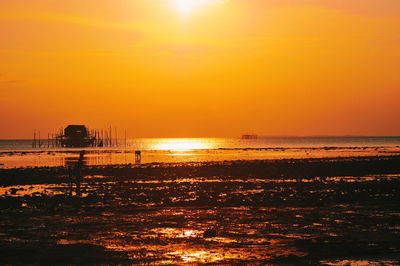 Scenic view of sea against orange sky