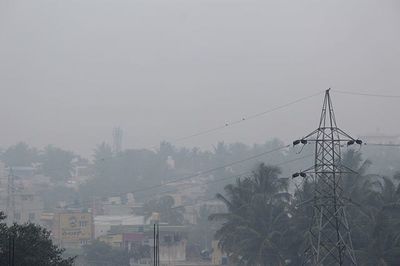 Buildings in city against cloudy sky