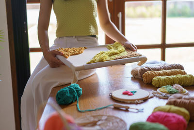 Midsection of woman preparing food on table