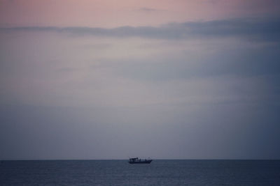 Sailboat sailing on sea against sky