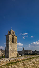 Low angle view of old building against blue sky