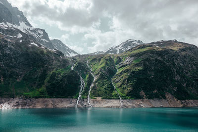 Scenic view of snow covered mountains against sky