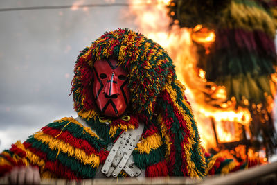 Close-up of person wearing multi colored costume